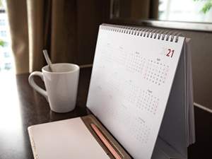 desk calendar next to coffee cup